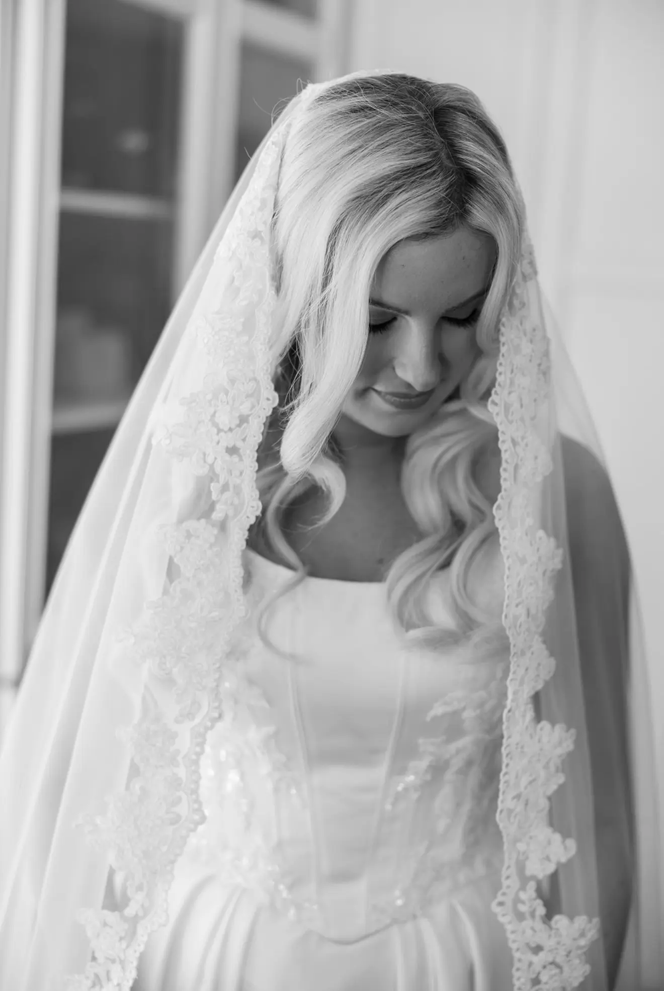 A bride in a lace-edged veil.