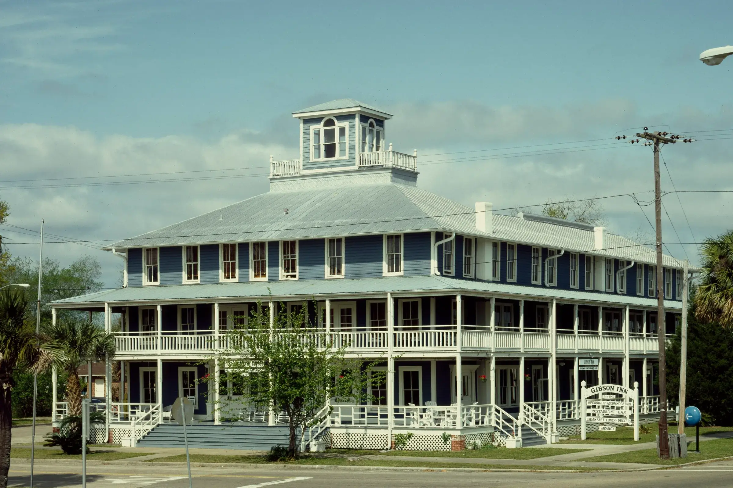 The Gibson Inn, a blue clapboard hotel of 1907 with white wraparound porches.