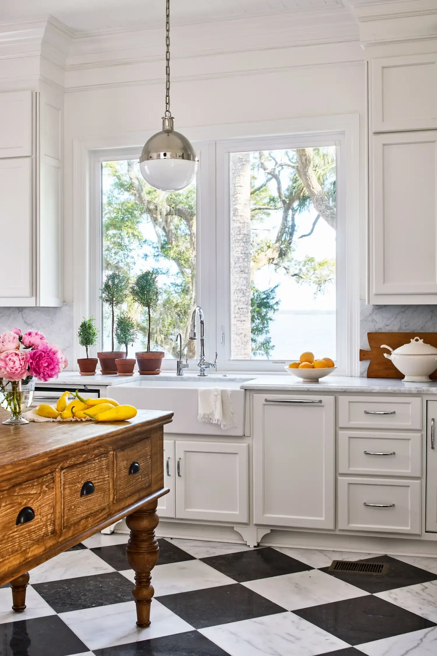 The kitchen with its marble checkerboard floor and antique island.