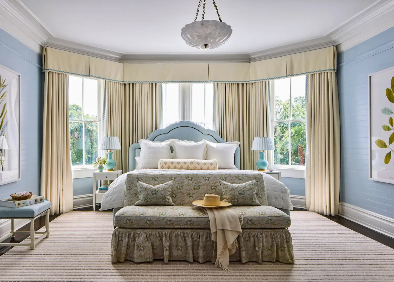 The principal bedroom, pale blue with a bay window.